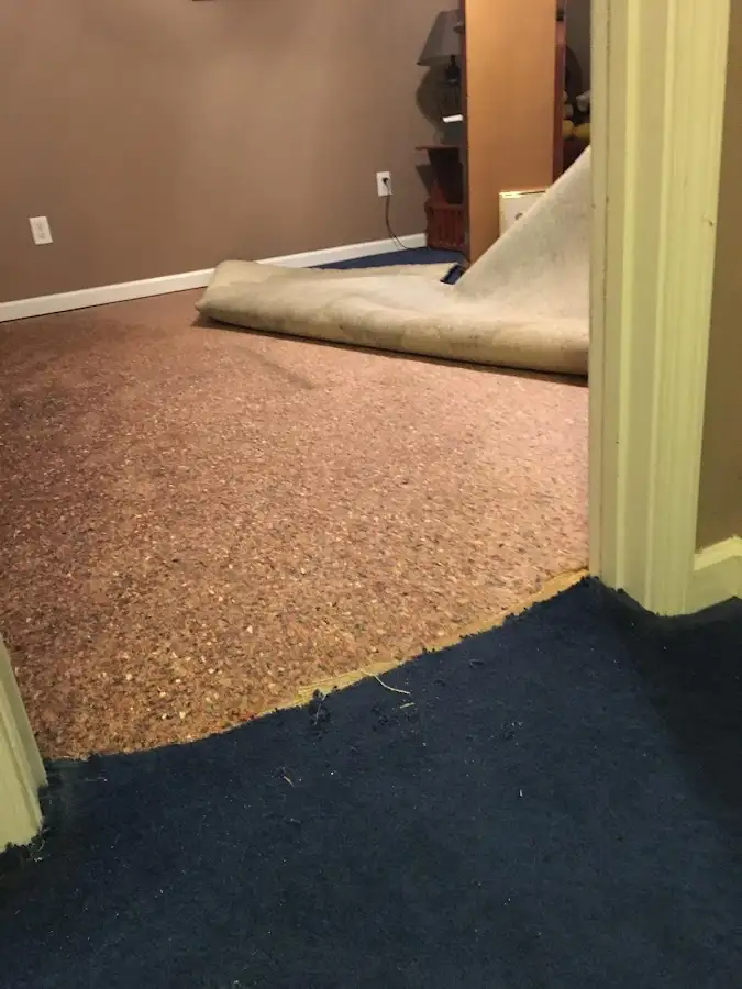 Carpet pad removal revealing water damage during Drying & Dehumidification in Patton